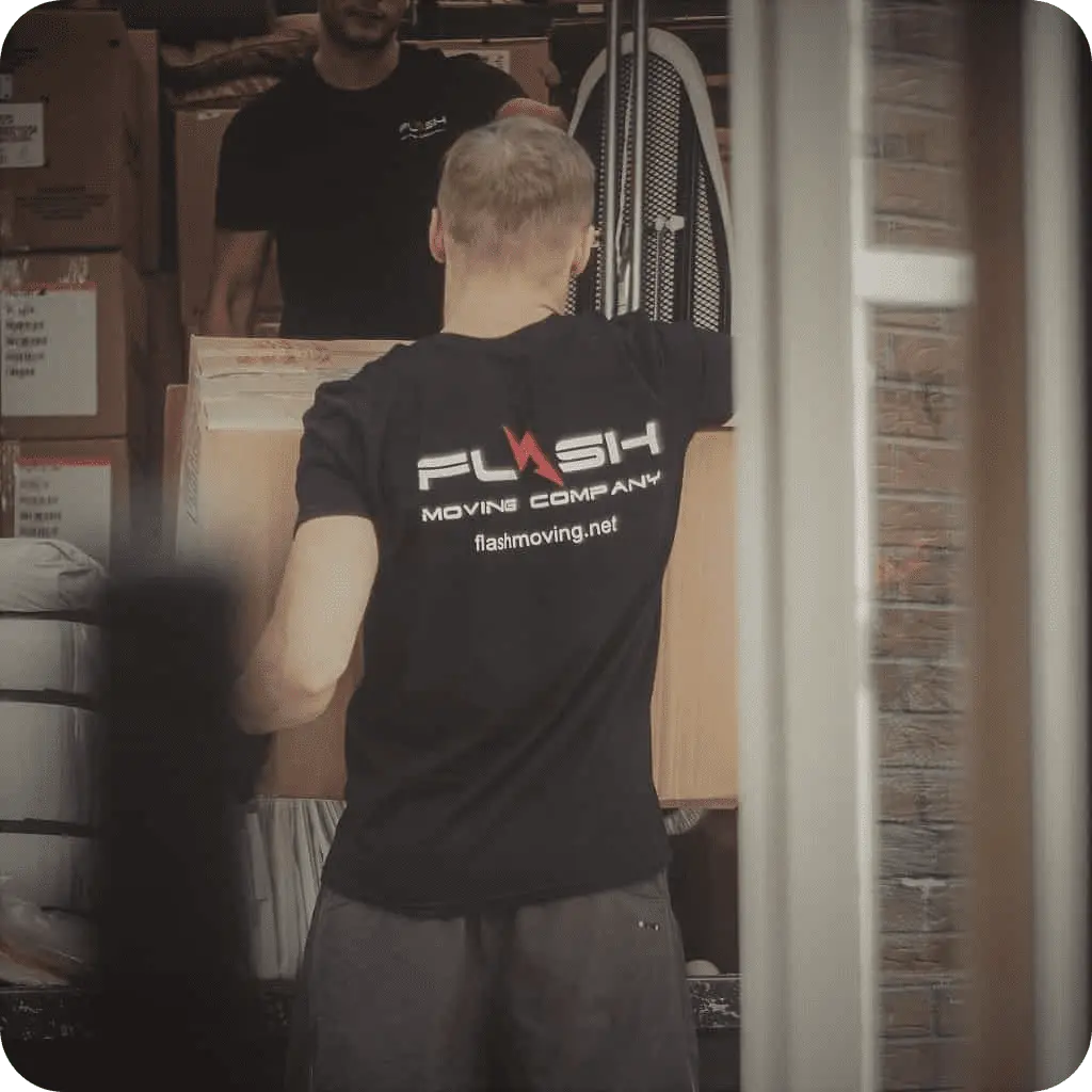 Flash Moving & Storage mover loading labeled boxes into truck – sudbury movers MA